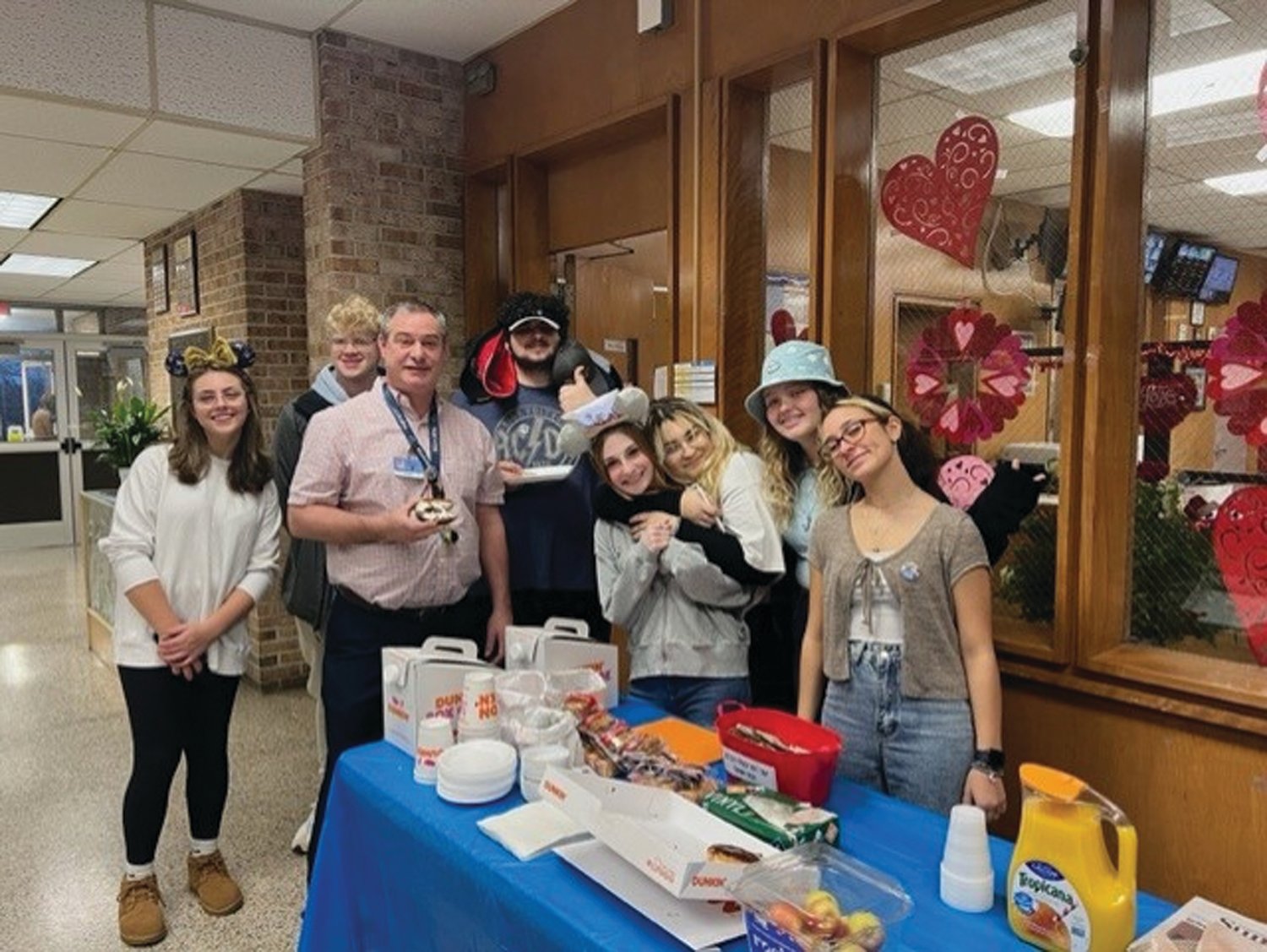 MAD HATTERS: From left to right, Lauren Dixon, Jackson Troxell, Ronald Lamoureux, Benjamin Monahan, Katelyn Loffler, Detinee Costa, Trinity Blondin and Eliyanha Negron pose for a photo on Crazy Hat Day.